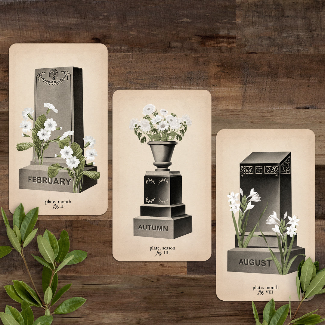 the february headstone, spring urn and august headstone on a wooden background
